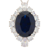 Oval blue sapphire sterling silver pendant surrounded by sparkling gemstones, perfect for elegant occasions.